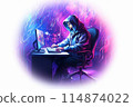 A man wearing a hoodie is seated at a desk, utilizing a laptop 114874022