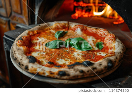 Pizza displayed on table near pizza oven, ready to eat 114874390