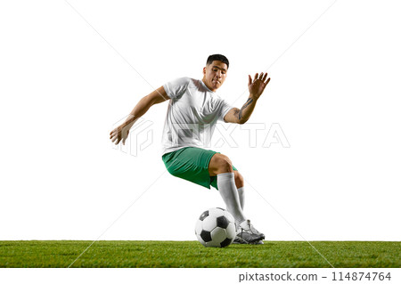 Young athletic man training dribbling technique in motion on green lash field against white studio background. 114874764