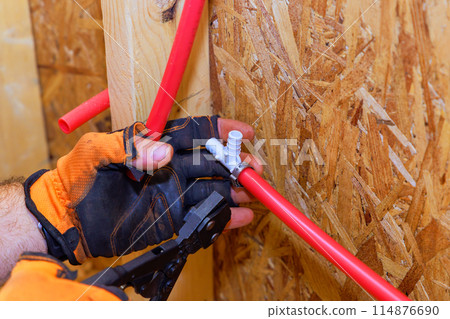 Installation of PVC plastic water pipes in house by plumber connection to water pipes 114876690