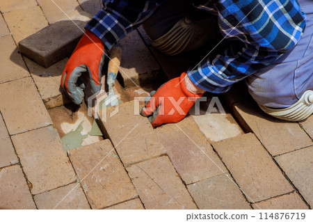 Replacement damaged brick path is process of rebuilding damaged pavement 114876719