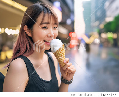 A woman eating soft serve ice cream because it's hot 114877177