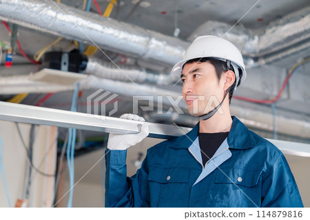 Carpenters bringing materials to the site 114879816