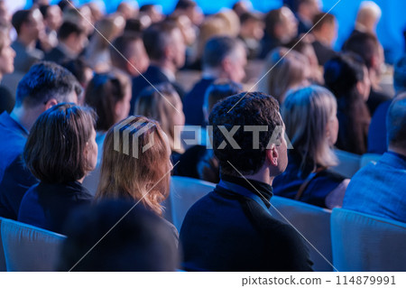 Audience attentively listening at a professional conference event Audience attentively listening at a professional conference event 114879991