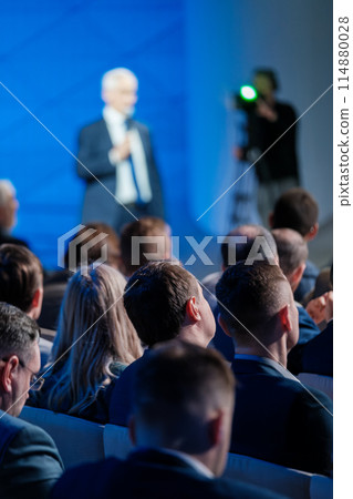 Businessman speaking at a corporate audience conference Businessman speaking at a corporate audience conference 114880028