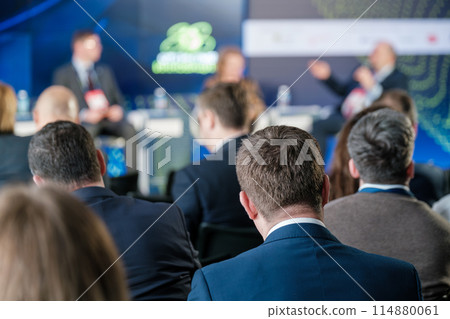 Business professionals attending a conference presentation 114880061