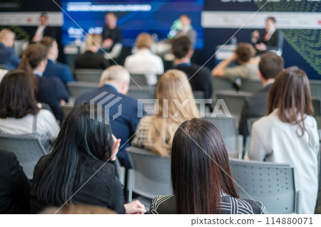 Professionals attentively listening at a corporate conference Professionals attentively listening at a corporate conference 114880071