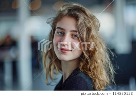Young woman smiling confidently with soft background lighting Young woman smiling confidently with soft background lighting 114880138