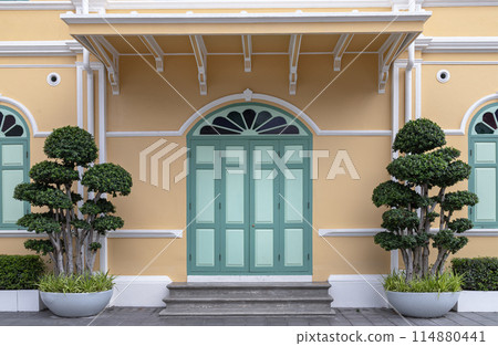 Ficus Bonsai Multi Heads in two pots are between the green door entrance. Ficus Bonsai Multi Heads in two pots are between the green door entrance. 114880441