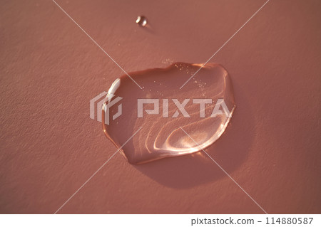 Beautiful volumetric drop of cosmetic product on a pink background. 114880587