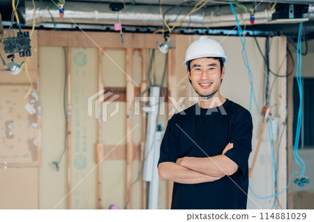 Construction site supervisor with arms folded Construction site supervisor with arms folded 114881029
