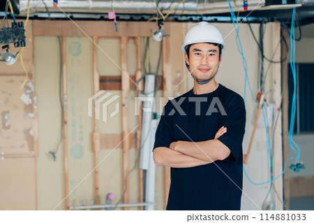 Construction site supervisor with arms folded Construction site supervisor with arms folded 114881033