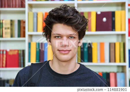 Headshot portrait of college student guy inside library of educational building Headshot portrait of college student guy inside library of educational building 114881901