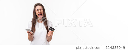Portrait of uneasy annoyed and angry young brunette female in t-shirt yelling pissed-off as checking bank account, have no money on credit card, or it expired, hold mobile phone, white background 114882049