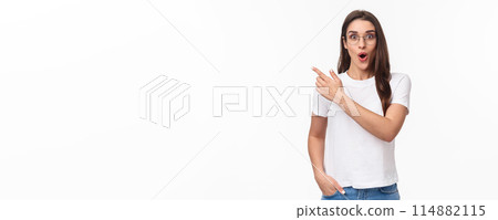 Portrait of impressed and enthusiastic, thrilled brunette female student talking about great opportunity travelling abroad, studying cool university program, pointing finger upper left corner Portrait of impressed and enthusiastic, thrilled brunette female student talking about great opportunity travelling abroad, studying cool university program, pointing finger upper left corner 114882115