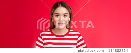 Close-up glamour attractive modern asian blond girl wear wireless white earphones smiling pleased, listening music headphones, enjoy perfect sound new earbuds, stand red background casually Close-up glamour attractive modern asian blond girl wear wireless white earphones smiling pleased, listening music headphones, enjoy perfect sound new earbuds, stand red background casually 114882214