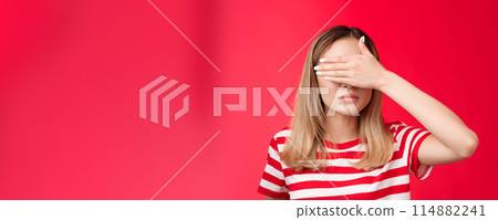 Serious-looking intense asian woman cover sight, hold palm on eyes unwilling see bad scene look focused tensed and pressured standing red background awaiting something happen Serious-looking intense asian woman cover sight, hold palm on eyes unwilling see bad scene look focused tensed and pressured standing red background awaiting something happen 114882241