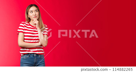 Hmm maybe. Girl pondering interesting idea, thinking touch chin thoughtful, look up smiling delighted, have interesting good plan, decided what order friend b-day online, red background 114882265