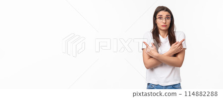 Waist-up of indecisive, clueless good-looking caucasian female in glasses, cant decide, pointing fingers sideways left and right, shrugging and looking confused, asking for help in taking decision Waist-up of indecisive, clueless good-looking caucasian female in glasses, cant decide, pointing fingers sideways left and right, shrugging and looking confused, asking for help in taking decision 114882288
