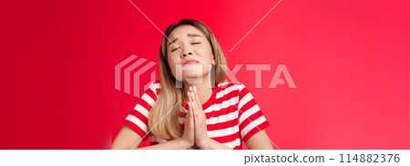 Close-up silly hopeful asian girl blond hairstyle, asking god help, hold hands pray, supplicating raise head up closed eyes, making wish, anticipating miracle, pleading lord dream come true Close-up silly hopeful asian girl blond hairstyle, asking god help, hold hands pray, supplicating raise head up closed eyes, making wish, anticipating miracle, pleading lord dream come true 114882376