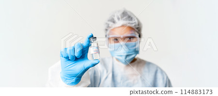 Portrait of asian doctor or nurse in personal protective equipment, female healthcare worker showing covid-19 vaccine, coronavirus vaccination concept Portrait of asian doctor or nurse in personal protective equipment, female healthcare worker showing covid-19 vaccine, coronavirus vaccination concept 114883173