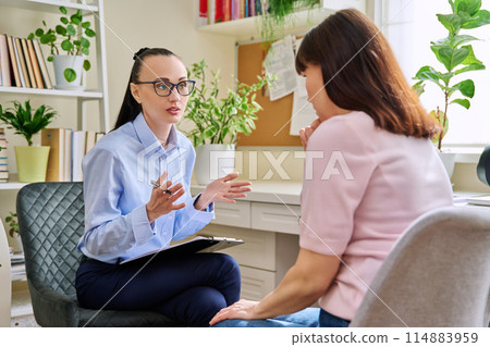 Professional mental psychologist at therapy session with female patient 114883959