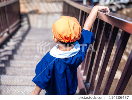 Kindergartener going down the stairs Kindergartener going down the stairs 114886487