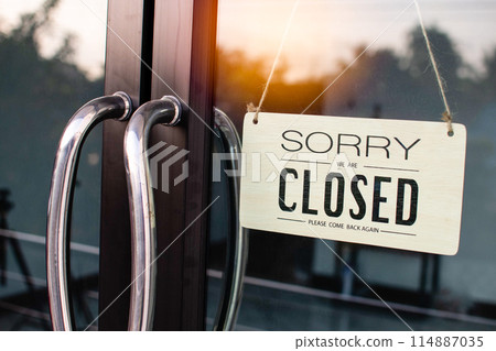 A sign hanging from a window that says Sorry We Are Closed A sign hanging from a window that says Sorry We Are Closed 114887035