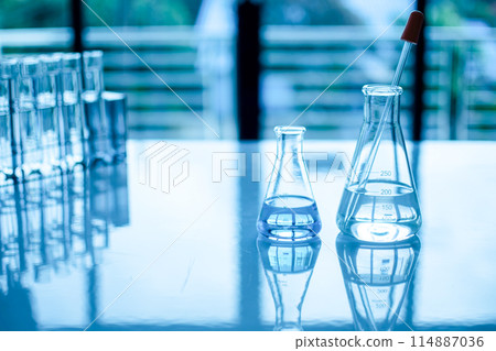 Two beakers of water sit on a table Two beakers of water sit on a table 114887036