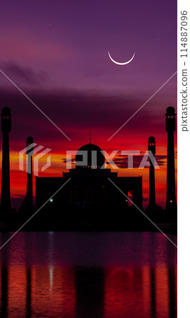 A beautiful sunset over a city with a large mosque in the background A beautiful sunset over a city with a large mosque in the background 114887096