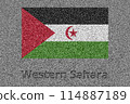The flag of Western Sahara painted on a stone slab with the words "Western Sahara" carved into it 114887189
