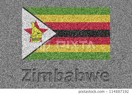 The Zimbabwean flag painted on a stone slab with the word "Zimbabwe" carved into it 114887192