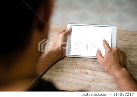 A man is holding a tablet with a white screen A man is holding a tablet with a white screen 114887217