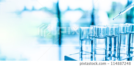 A row of clear glass beakers filled with water 114887248