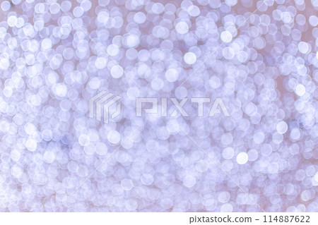 The image is a blurry, white background with many small 114887622