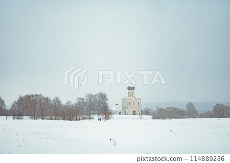 a church in winter in the middle of a snow-covered field 114889286