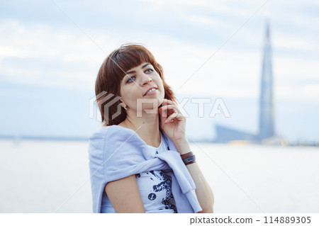 a girl on the background of water and a tower a girl on the background of water and a tower 114889305