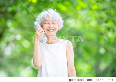 Gray-haired woman, fresh greenery, hydration Gray-haired woman, fresh greenery, hydration 114890873