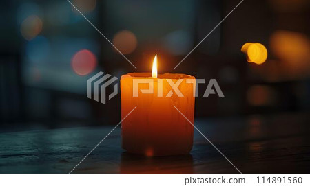 Candle burning on table in dark room. The evening lighting illuminates the candle flame. A heartwarming, peaceful and romantic concept background with copy space area. Bright orange light from the lit Candle burning on table in dark room. The evening lighting illuminates the candle flame. A heartwarming, peaceful and romantic concept background with copy space area. Bright orange light from the lit 114891560