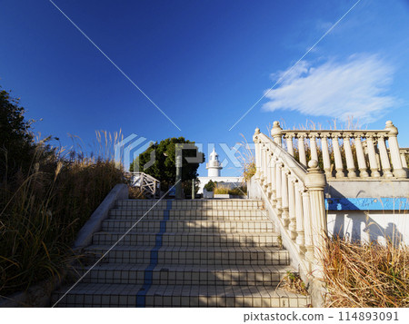 The white Jogashima Lighthouse stands on top of a white hill against the backdrop of a clear blue sky. The white Jogashima Lighthouse stands on top of a white hill against the backdrop of a clear blue sky. 114893091