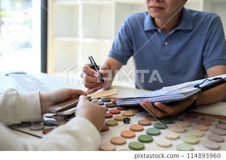 Female customer meeting with designer expert or decorator for choice home improvement materials Female customer meeting with designer expert or decorator for choice home improvement materials 114893960