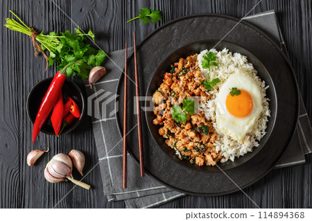 basil chicken stir fry with rice and fried egg 114894368