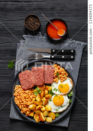 corned beef, baked beans, potatoes and fried eggs 114894373