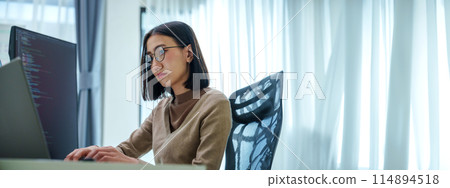 Asian prompt engineer develop coding app with software data sitting in front of computer monitor at office 114894518