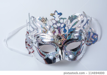 Closeup of glittering silver venetian carnival masquerade mask on white background 114894800