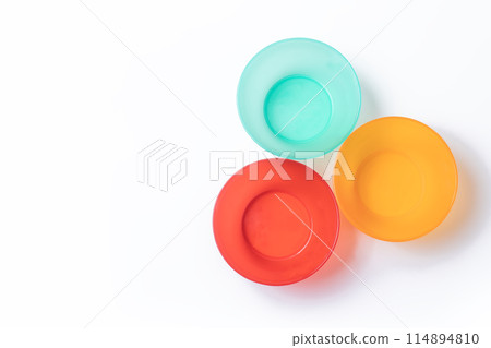 Vibrant plastic tableware set isolated on white background with copy space. 114894810