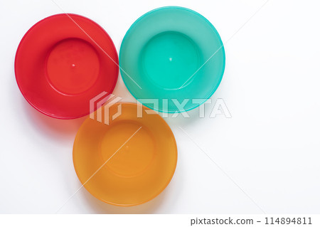 Colorful plastic tableware isolated on white background with copy space. Colorful plastic tableware isolated on white background with copy space. 114894811