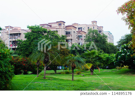 A picture of garden with residential building 114895176