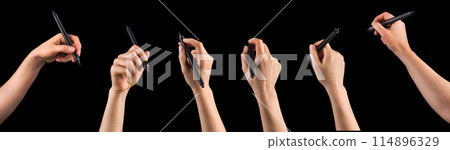 Hand holding digital graphic pen and drawing something isolated on black 114896329
