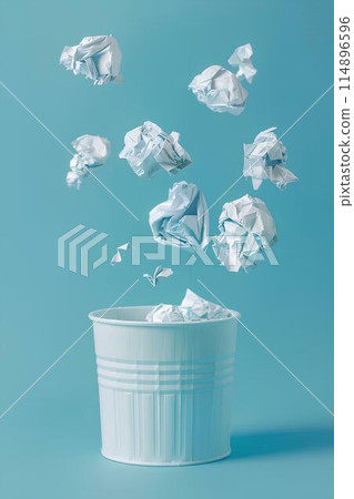 A paper trash can floating in the air with crumpled white papers against a light blue background in a minimal concept studio lighting style 114896596